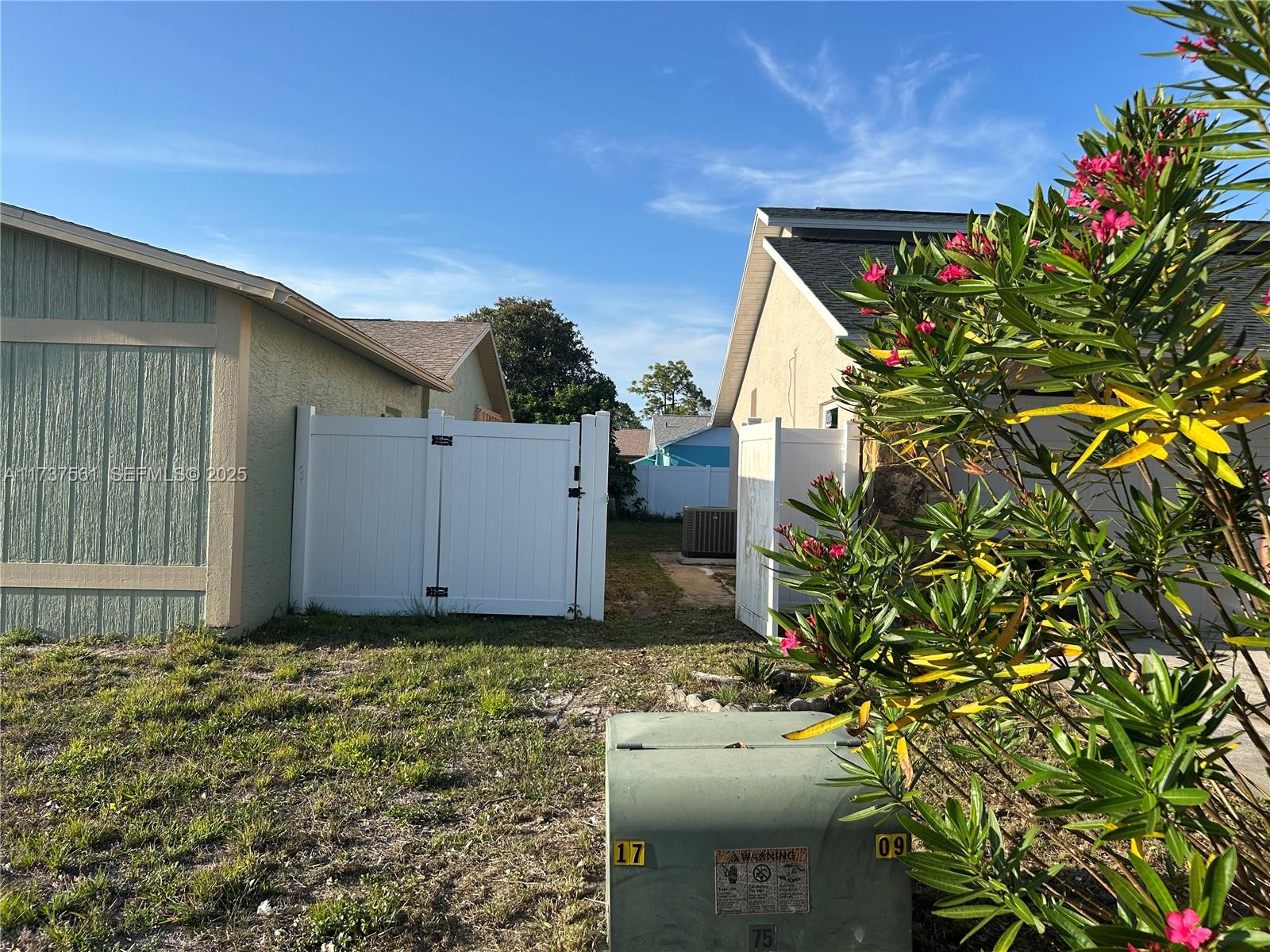 7403 Foxbloom Drive Port Richey, FL 34668 - Photo 6 of 45 a backyard of a house with lots of green space