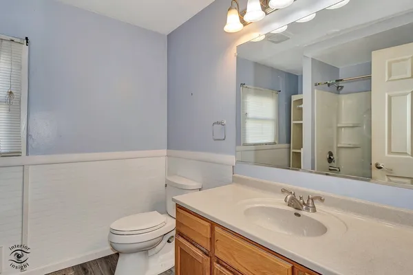 a bathroom with a sink vanity granite and toilet