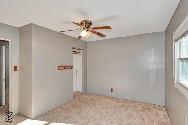 a view of room with window and ceiling fan