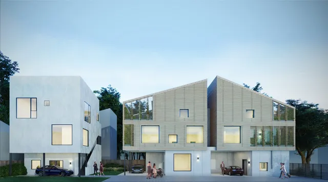 a front view of a residential apartment building with a yard