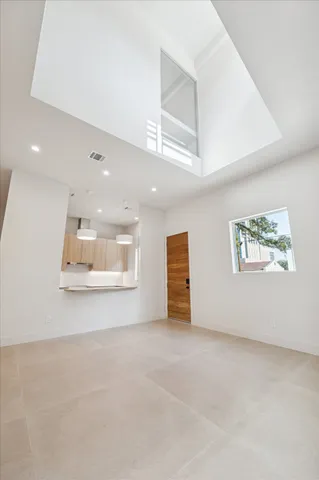 a kitchen with granite countertop a sink and a stove with white countertops