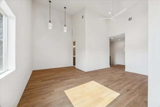 a view of room with stairs and wooden floor