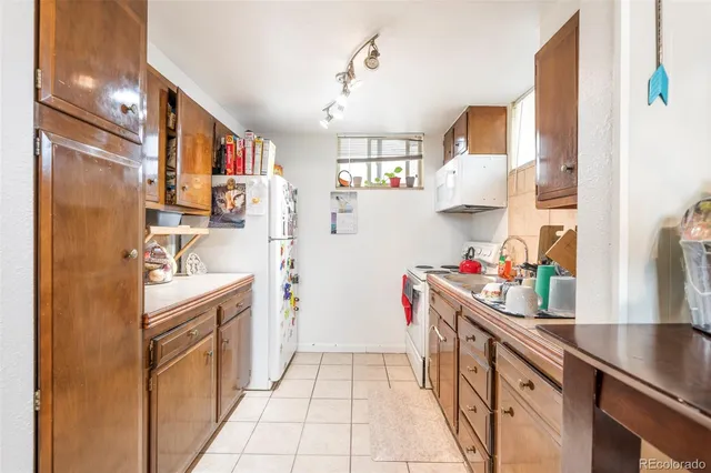 a kitchen with refrigerator and cabinets