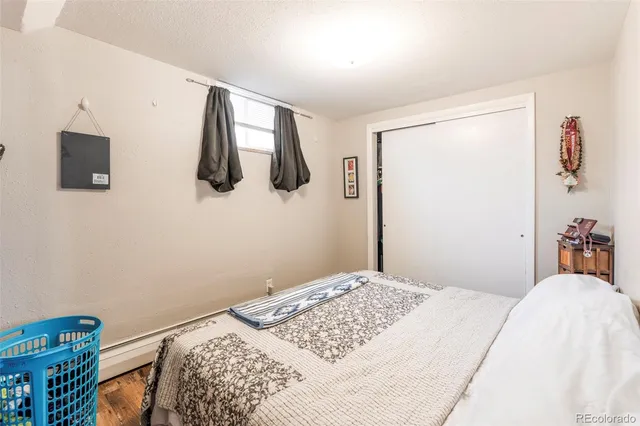 a bedroom with a bed and flat screen tv
