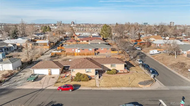 an aerial view of residential houses with city view