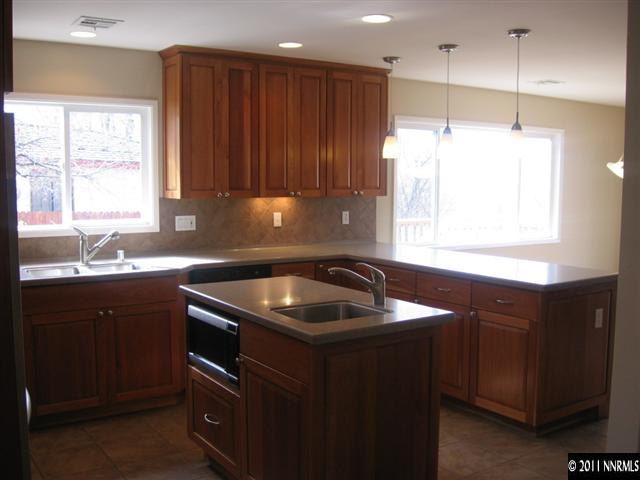2035 Regent Street Reno, NV 89509 - Photo 2 of 13 a kitchen with kitchen island granite countertop a sink window and cabinets
