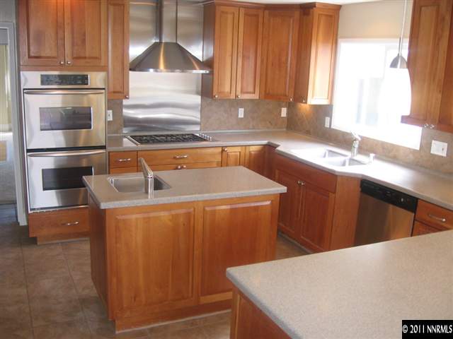 2035 Regent Street Reno, NV 89509 - Photo 3 of 13 a kitchen with stainless steel appliances a refrigerator and a sink