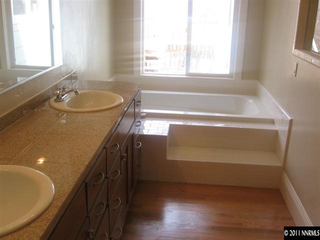 2035 Regent Street Reno, NV 89509 - Photo 8 of 13 a bathroom with a granite countertop sink a bathtub and window