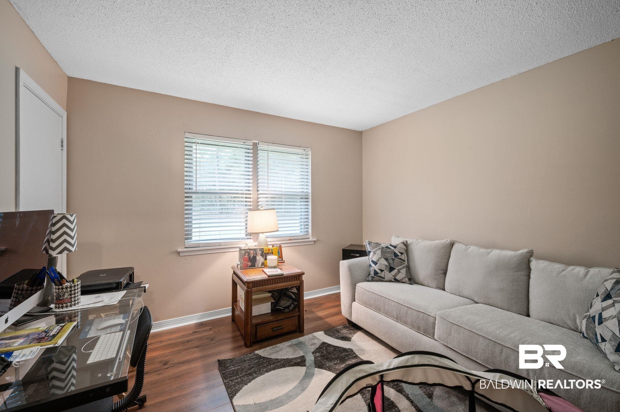 4566 McCrary Road, Unit A Semmes, AL 36575 - Photo 21 of 28 Living room with a textured ceiling and dark wood-type flooring