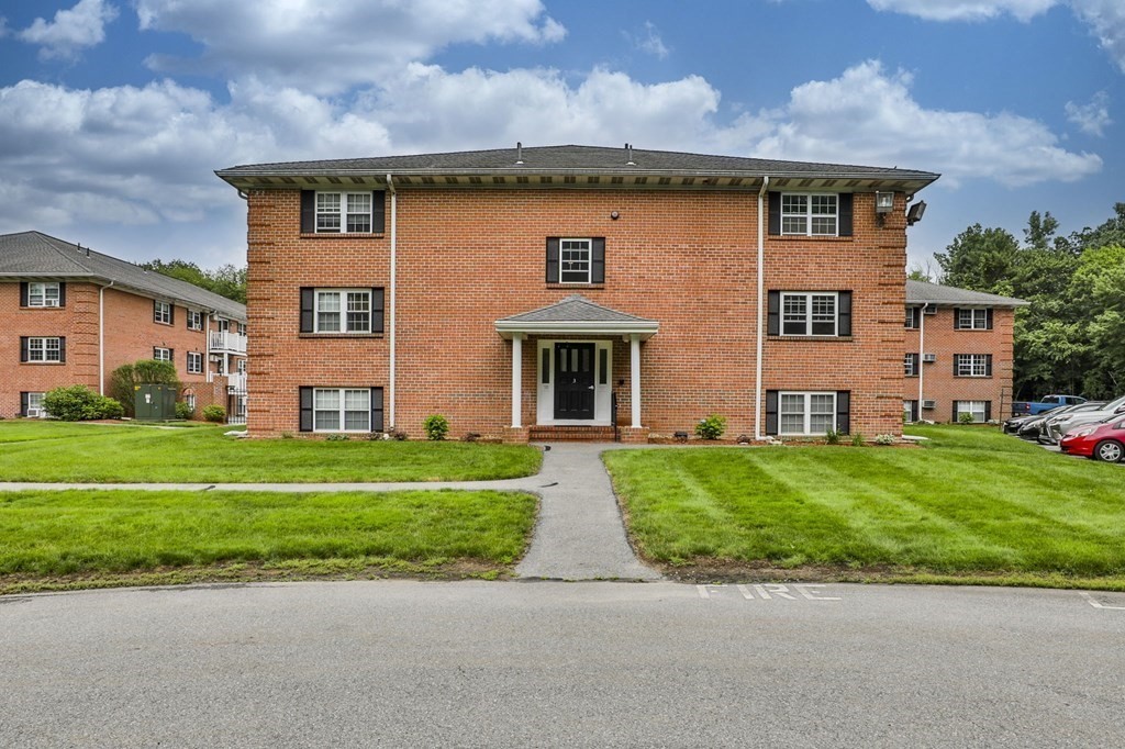 56 Leonard Road, Unit 56 Boxborough, MA 01719 - Photo 1 of 26 a front view of house with yard and green space