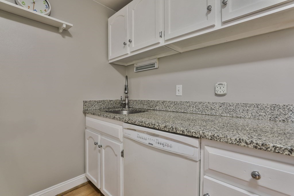56 Leonard Road, Unit 56 Boxborough, MA 01719 - Photo 11 of 26 a sink with white cabinets