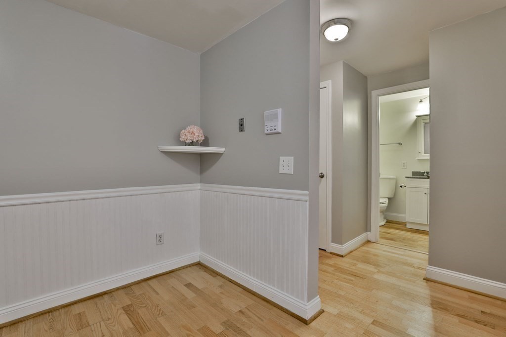 56 Leonard Road, Unit 56 Boxborough, MA 01719 - Photo 12 of 26 wooden floor in an empty room and a window