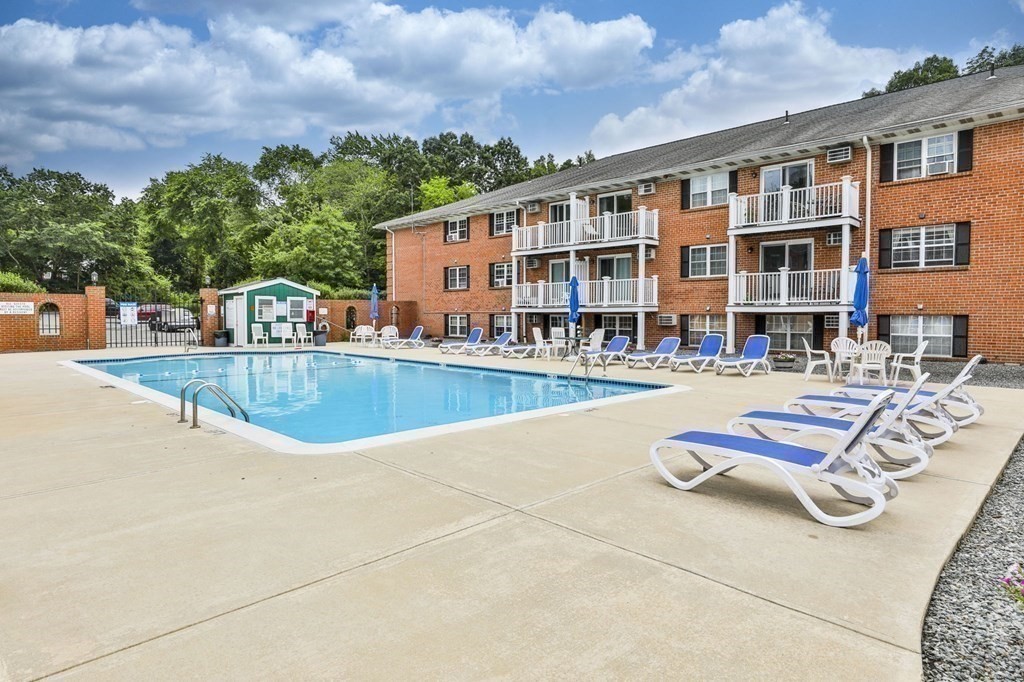 56 Leonard Road, Unit 56 Boxborough, MA 01719 - Photo 21 of 26 a view of a house with swimming pool and sitting area
