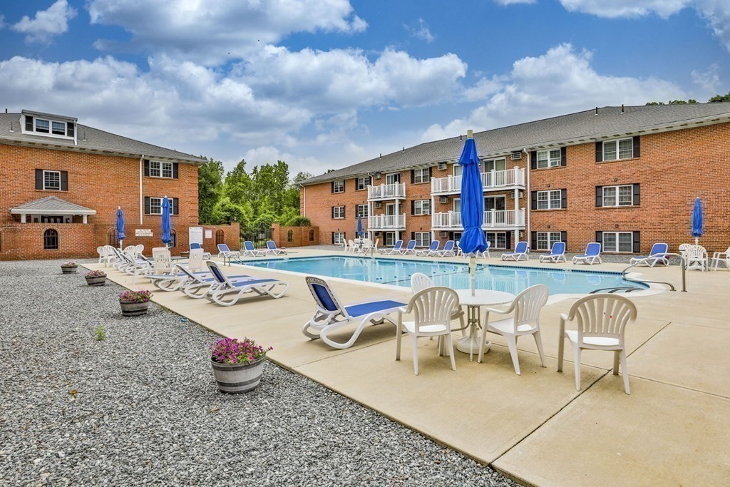 56 Leonard Road, Unit 56 Boxborough, MA 01719 - Photo 22 of 26 a building outdoor space with patio furniture and potted plants