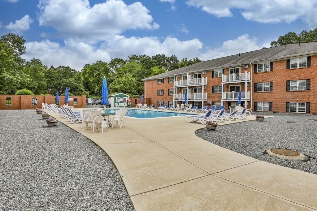 56 Leonard Road, Unit 56 Boxborough, MA 01719 - Photo 23 of 26 a row of pool with outdoor seating