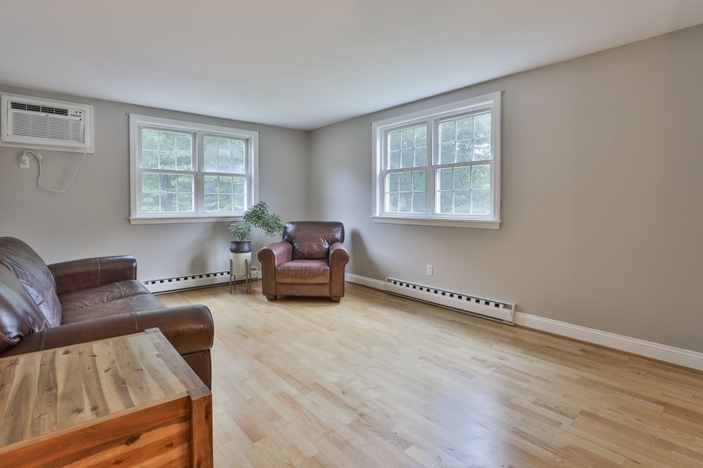 56 Leonard Road, Unit 56 Boxborough, MA 01719 - Photo 4 of 26 a living room with furniture and a window