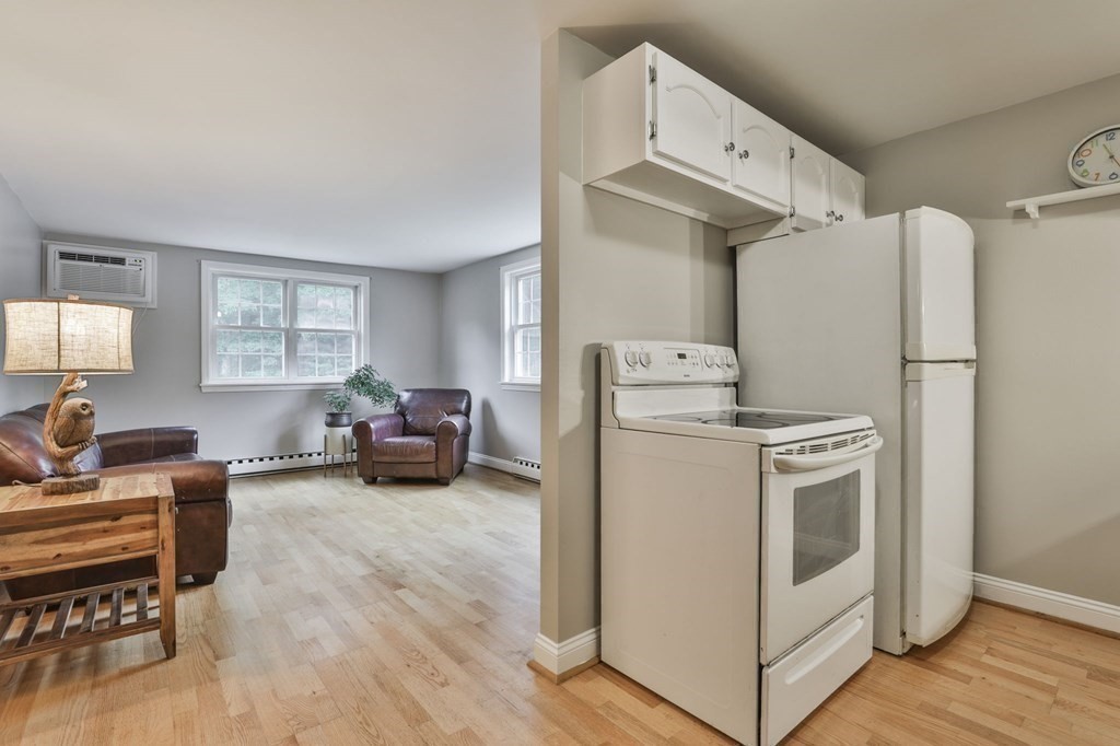 56 Leonard Road, Unit 56 Boxborough, MA 01719 - Photo 6 of 26 a view of kitchen with furniture and wooden floor