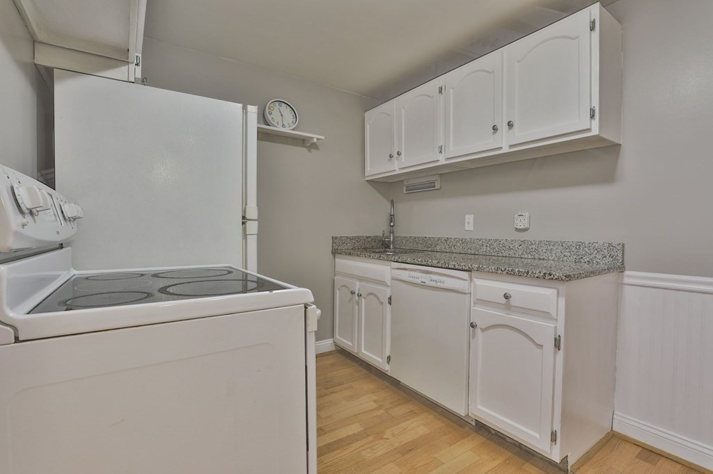 56 Leonard Road, Unit 56 Boxborough, MA 01719 - Photo 10 of 26 a utility room with sink dryer and washer