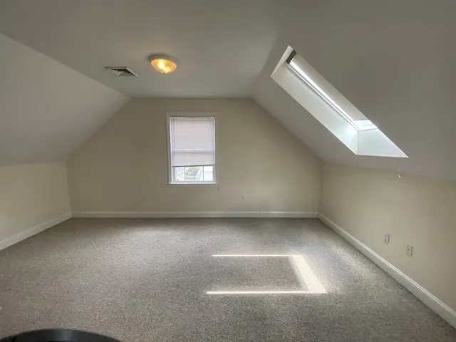 an empty room with a empty space and windows