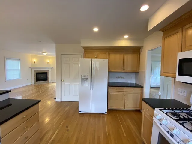 a kitchen with granite countertop a stove and a refrigerator