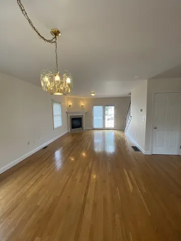 a view of a room with a chandelier fan and window