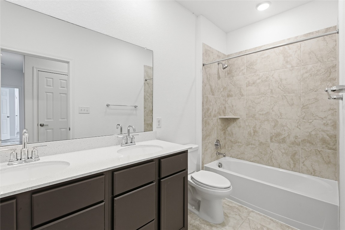 209 Thurman Holt Road Hutto, TX 78634 - Photo 10 of 32 a bathroom with a sink a toilet and shower