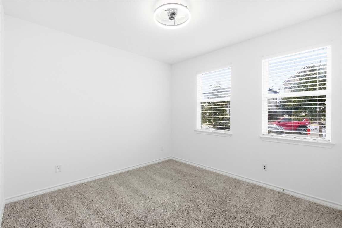 209 Thurman Holt Road Hutto, TX 78634 - Photo 13 of 32 an empty room with windows