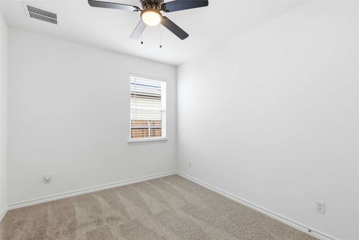 209 Thurman Holt Road Hutto, TX 78634 - Photo 15 of 32 an empty room with a window and a fan
