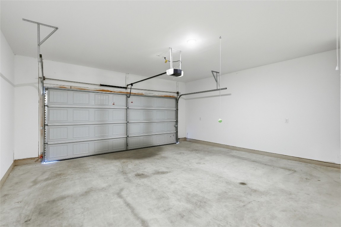 209 Thurman Holt Road Hutto, TX 78634 - Photo 17 of 32 Garage featuring baseboards