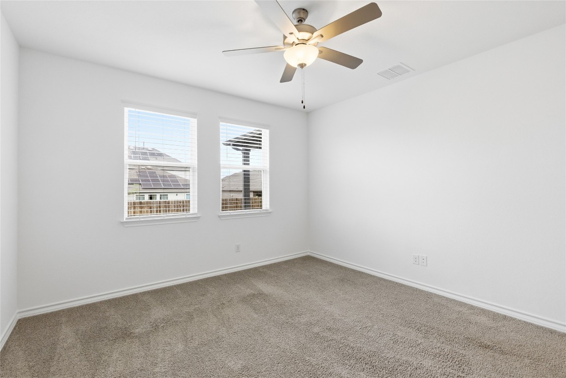 209 Thurman Holt Road Hutto, TX 78634 - Photo 19 of 32 an empty room with windows and fan