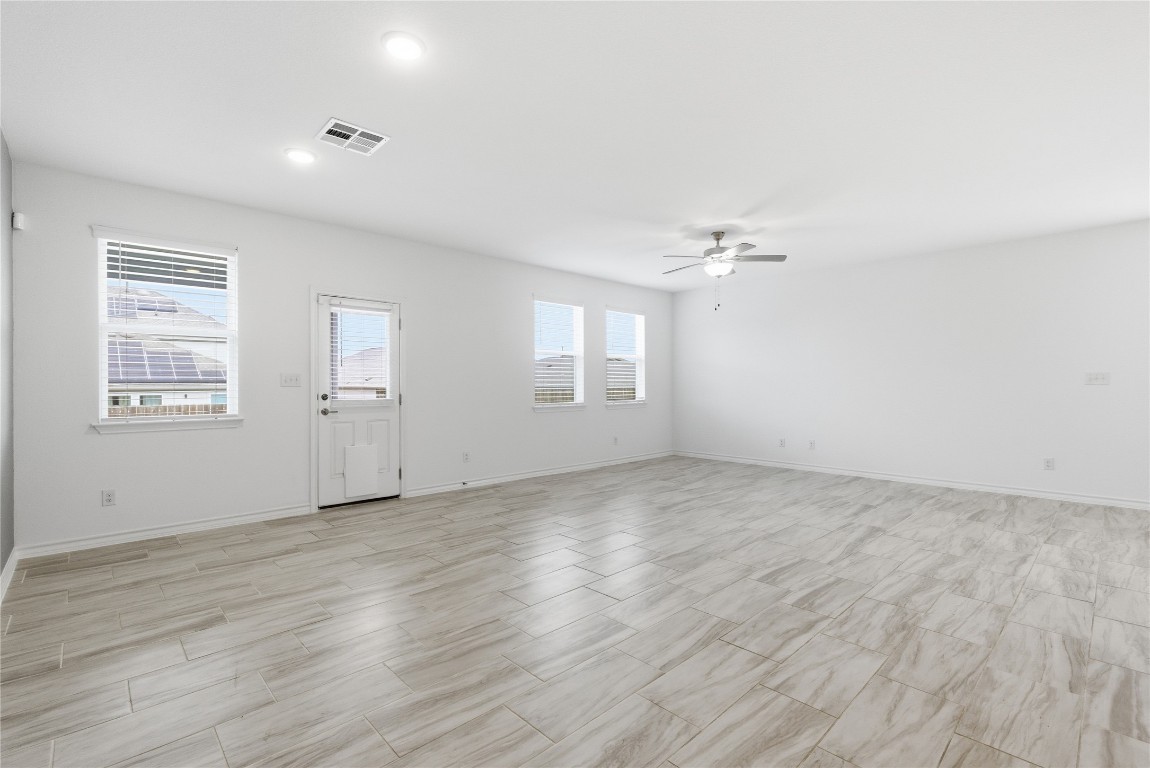 209 Thurman Holt Road Hutto, TX 78634 - Photo 4 of 32 wooden floor in an empty room with a window