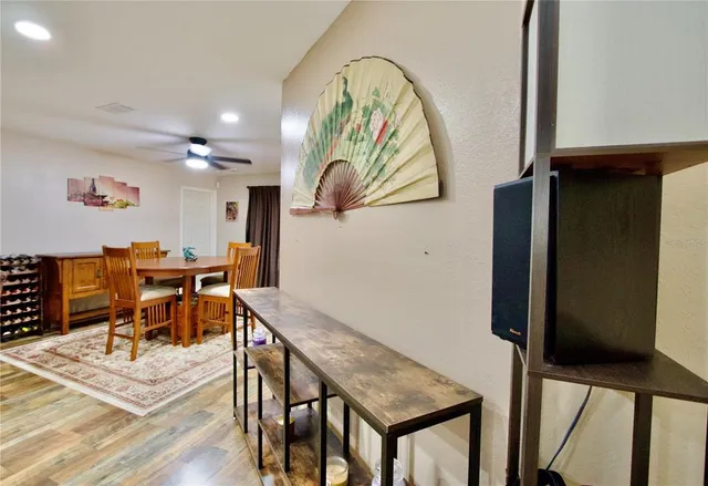 a view of a dining room with furniture and wooden floor