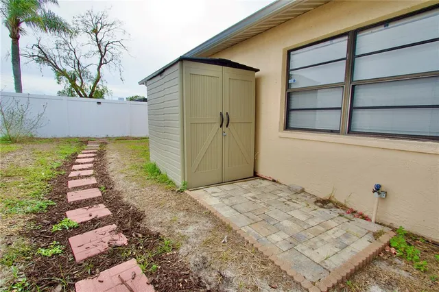 a backyard of a house with a yard and outdoor seating