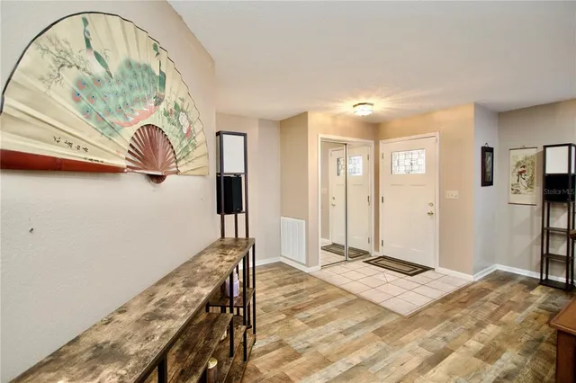 a bedroom with a bed and a painting on the wall