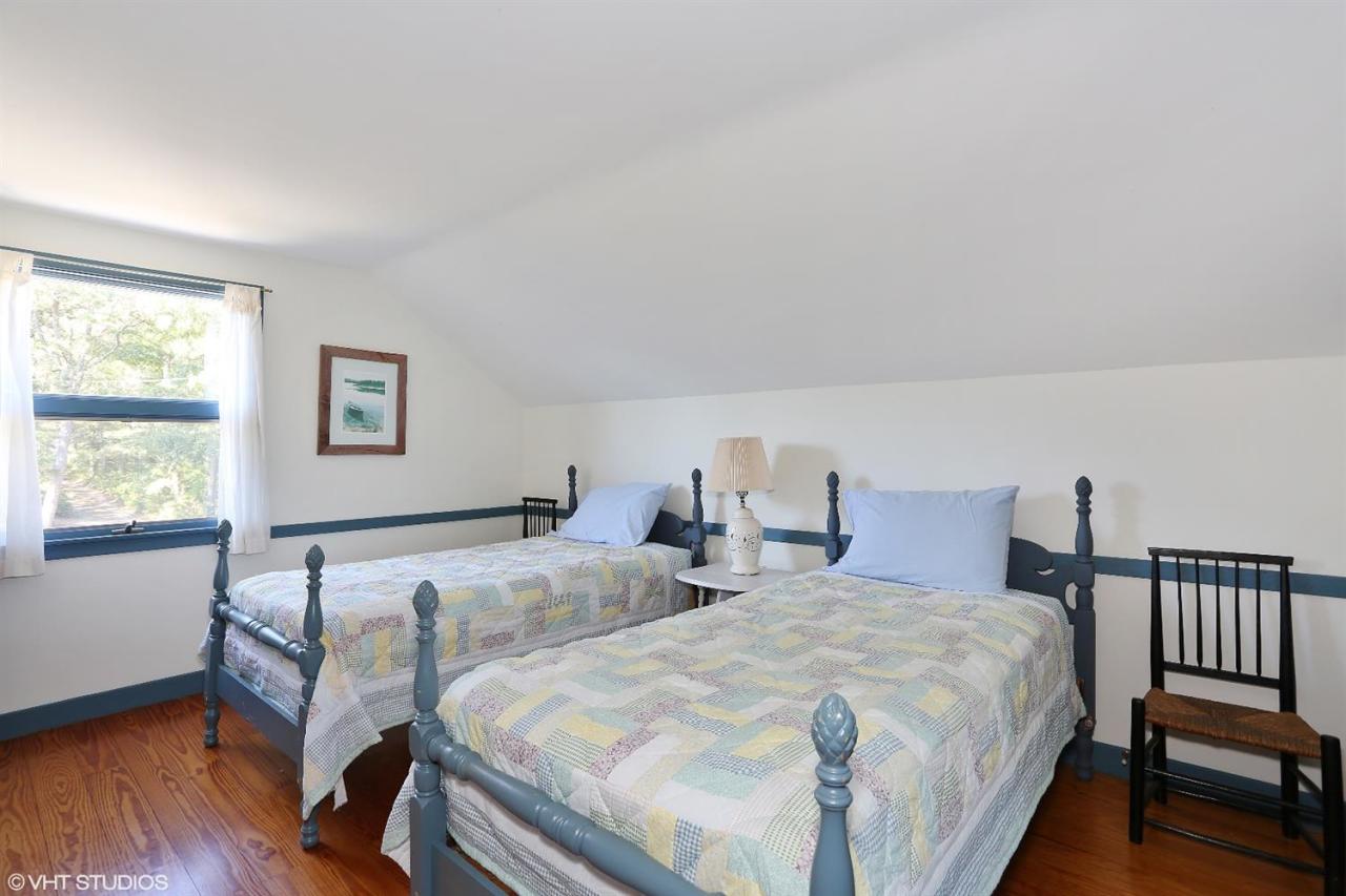 21 Riverside Road Mashpee, MA 02649 - Photo 14 of 14 a bedroom with two beds and wooden floor