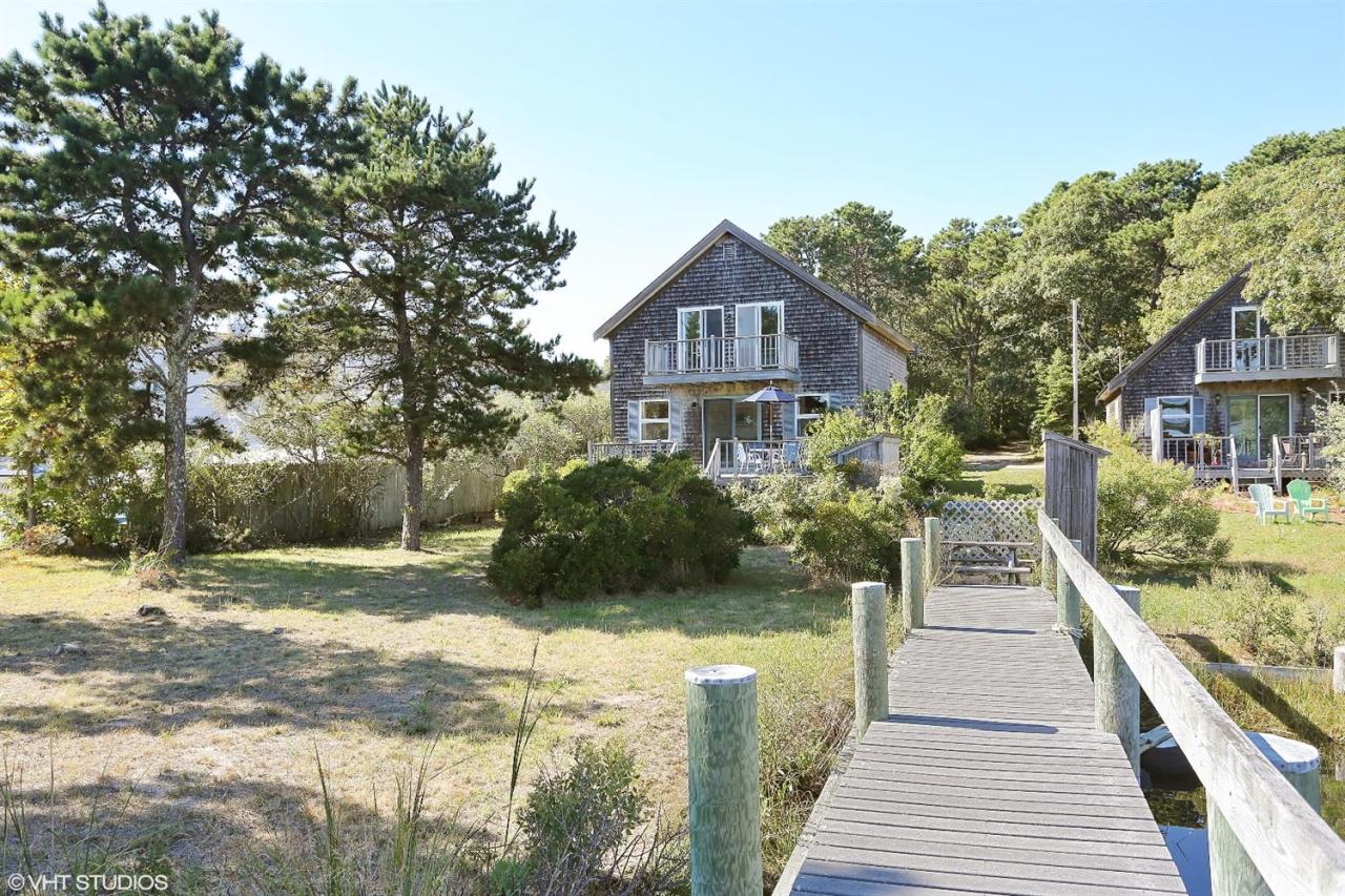 21 Riverside Road Mashpee, MA 02649 - Photo 3 of 14 a front view of a house with a yard