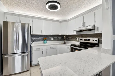 a kitchen with appliances a sink and a stove