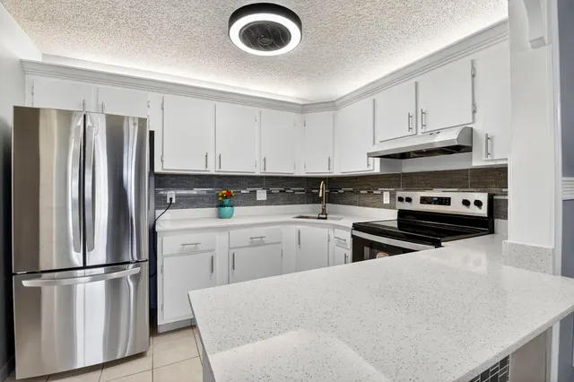 a kitchen with appliances a sink and a stove