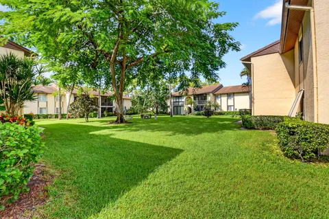 a view of house with backyard