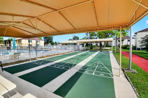 a view of a backyard with swimming pool