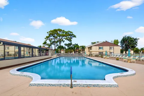 a view of a swimming pool with a chairs
