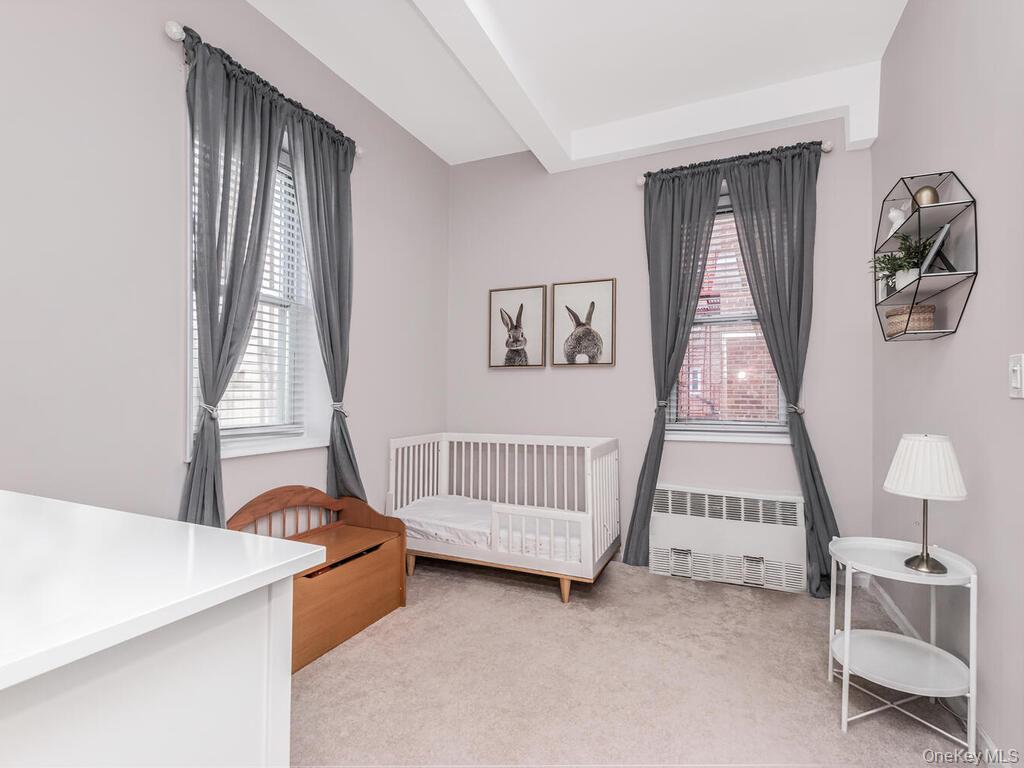 245 Rumsey Road, Unit 20 Yonkers, NY 10701 - Photo 12 of 14 a bedroom with a bed and a window