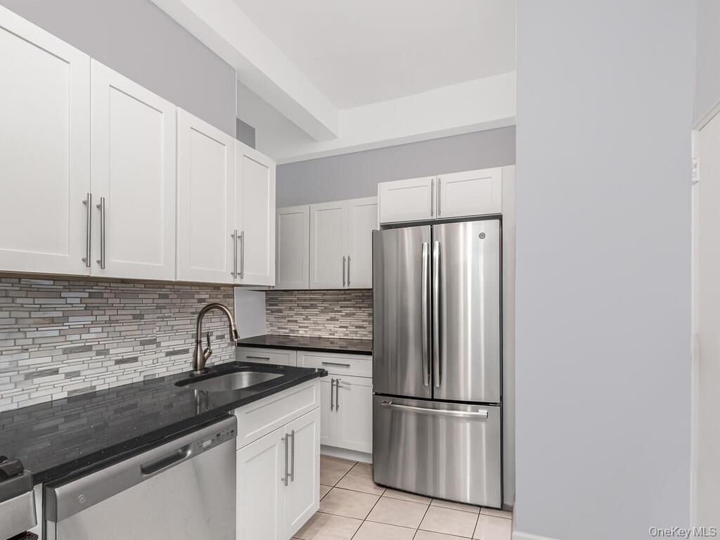 245 Rumsey Road, Unit 20 Yonkers, NY 10701 - Photo 8 of 14 a kitchen with stainless steel appliances granite countertop a refrigerator sink and cabinets