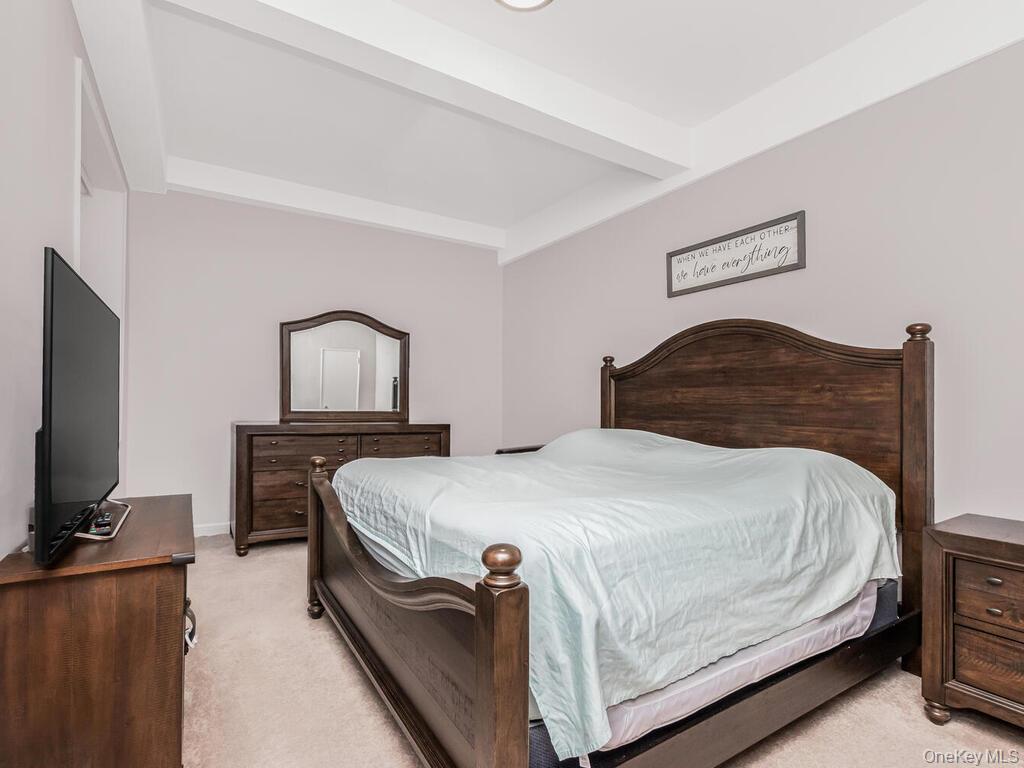 245 Rumsey Road, Unit 20 Yonkers, NY 10701 - Photo 10 of 14 a bedroom with a bed and a flat tv screen on dresser