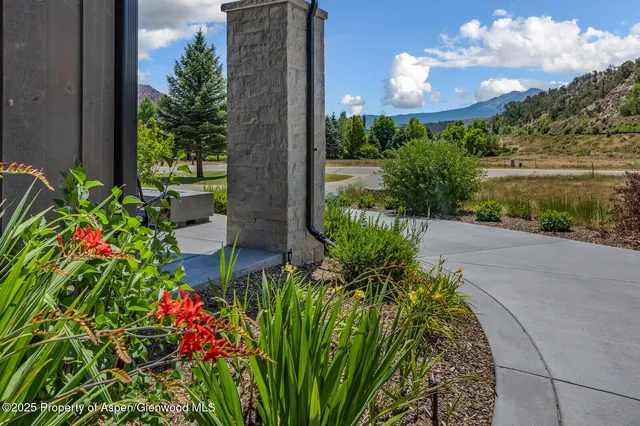 a kitchen with a stove a refrigerator and a dining table