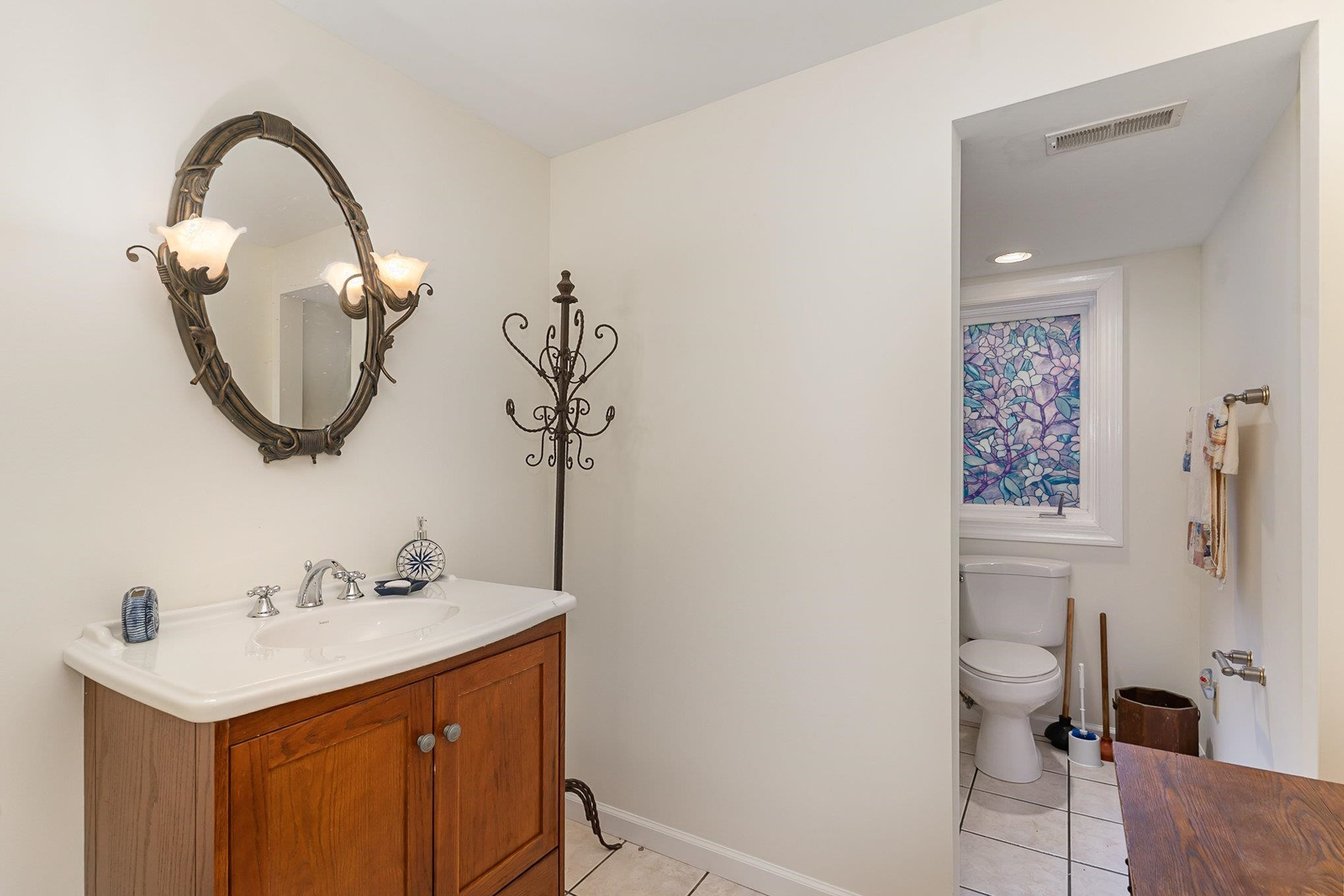 425 Sledge Road Louisburg, NC 27549 - Photo 17 of 30 a bathroom with a sink a toilet and a mirror
