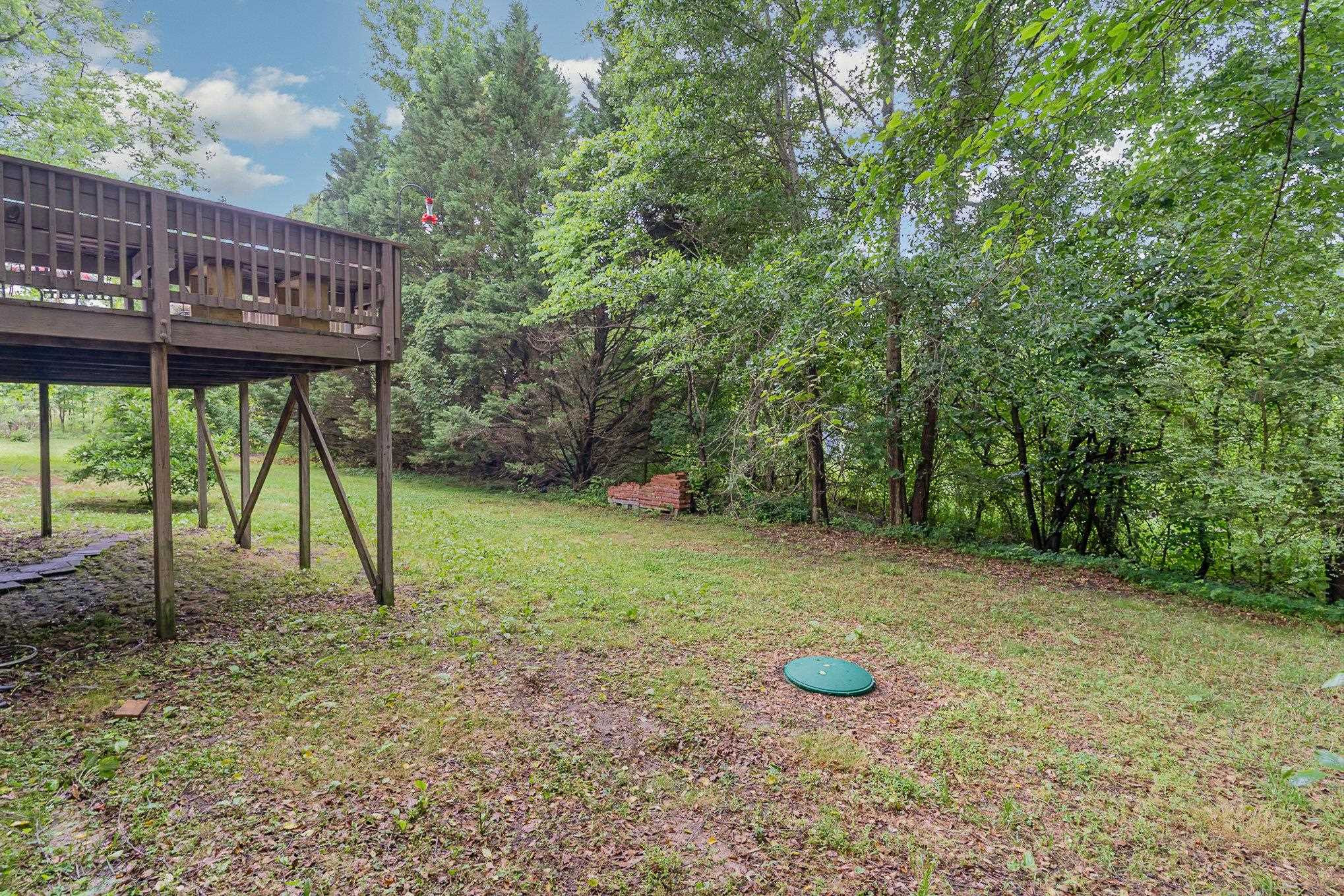 425 Sledge Road Louisburg, NC 27549 - Photo 23 of 30 a view of a wooden deck with a backyard