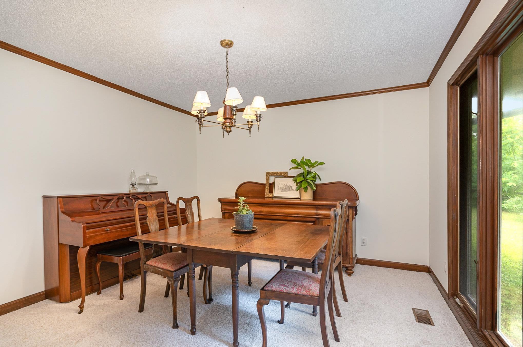 425 Sledge Road Louisburg, NC 27549 - Photo 8 of 30 a dining room with furniture a chandelier and wooden floor