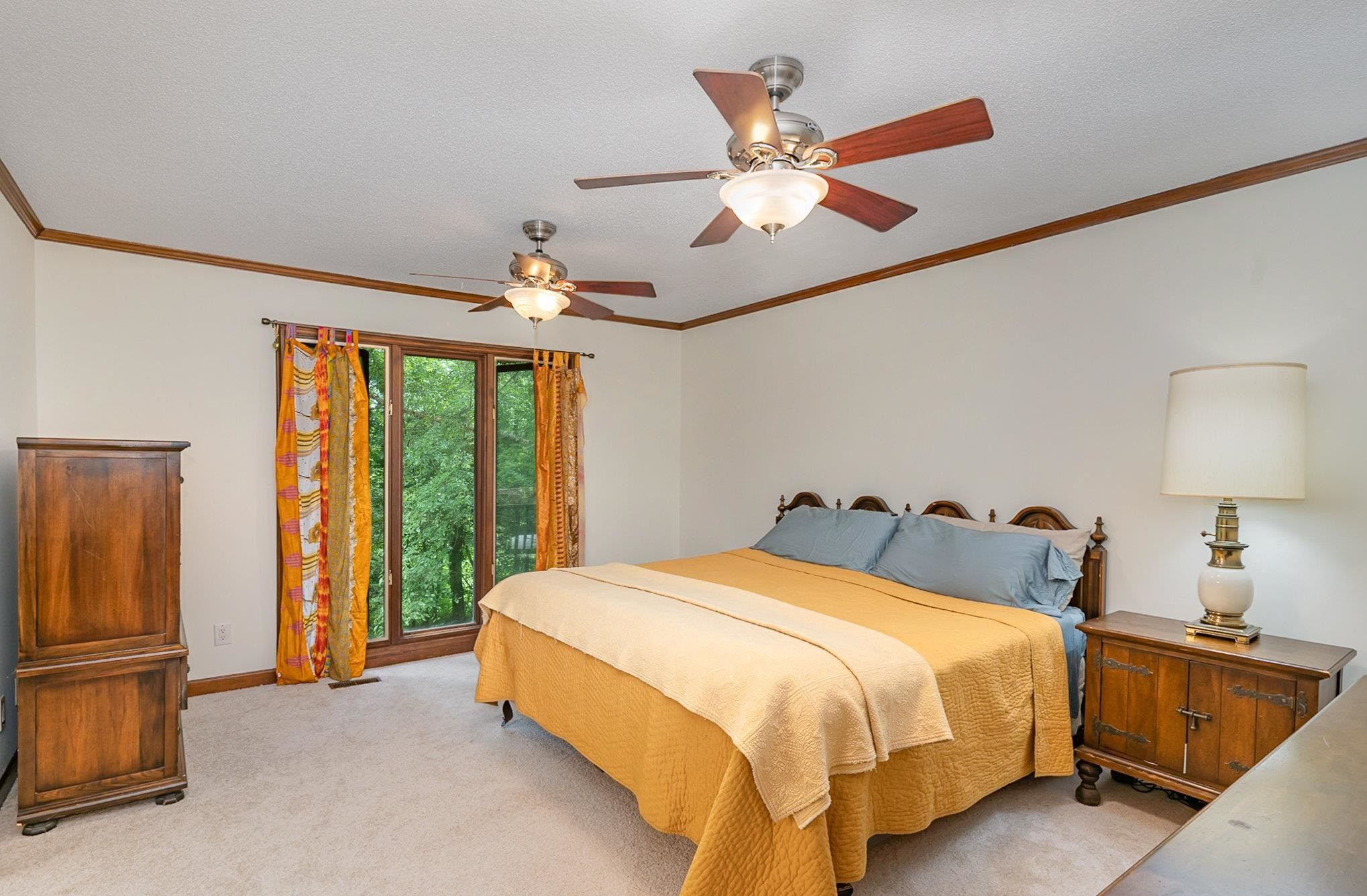 425 Sledge Road Louisburg, NC 27549 - Photo 9 of 30 a spacious bedroom with a bed and a chandelier