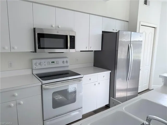 a kitchen with a stove microwave and refrigerator